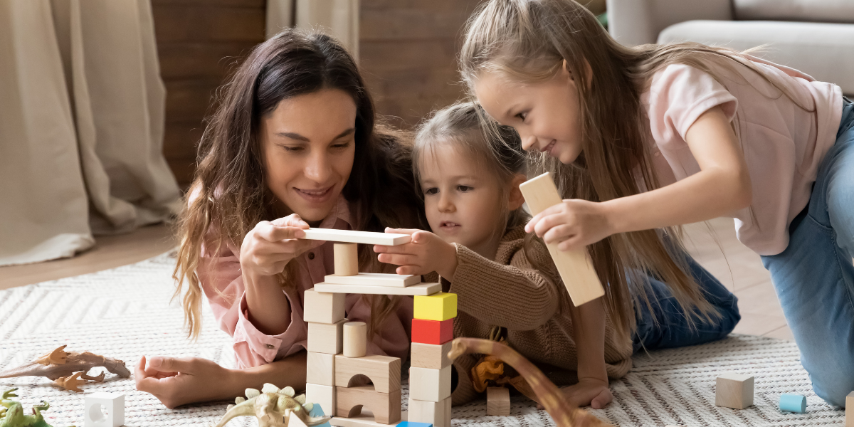 Babysitter playing with two children 